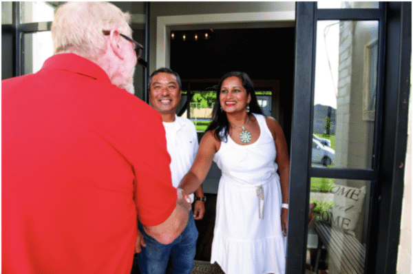 happy homeowners shaking hands with technician after great hvac services in pasadena