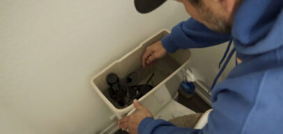 Technician working on toilet