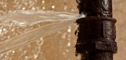 rusted pipe burst spraying water