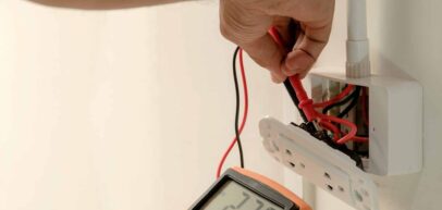 electrician inspecting outlet