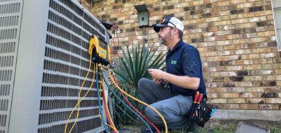 Tech fixing outdoor AC system
