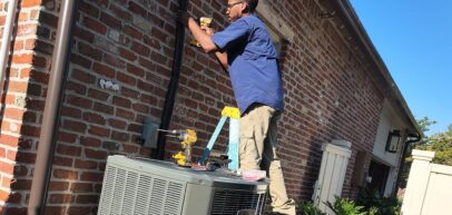 Tech installing AC outside home