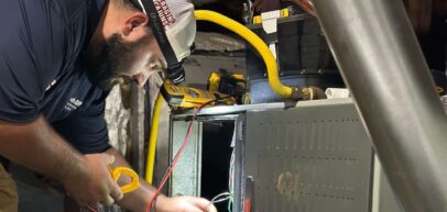 Tech installing new Trane furnace